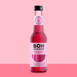 Bottle of Bon Accord Rhubarb soda against pink backdrop