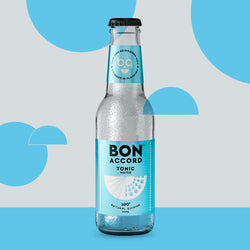 A bottle of Bon Accord Tonic Water against a blue backdrop