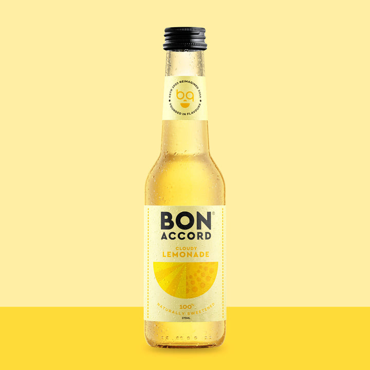 Bottle of Bon Accord Cloudy Lemonade against bright yellow backdrop