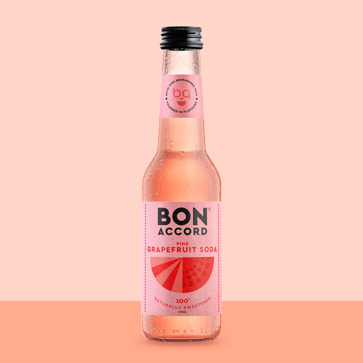 Bottle of Bon Accord Pink Grapefruit Soda against peach coloured backdrop