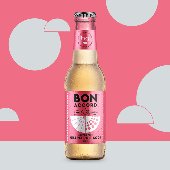 Bottle of Bon Accord Salted Pink Grapefruit soda against pink and white backdrop